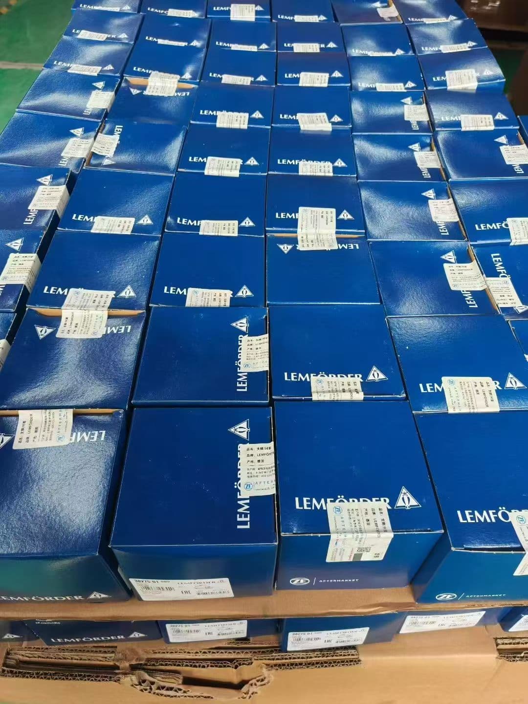 整齐堆放的蓝色伦福德汽车零件包装箱,带有白色标签和品牌标志。